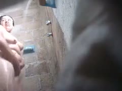 My spy camera records Hawt Fattie washing her hair and having a shower.
